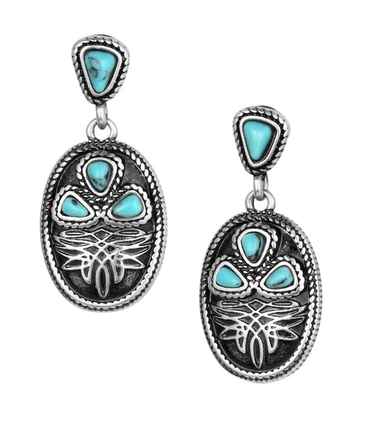 Front view of the women's antiqued silver dangle earrings featuring the boot stitch design and crafted turquoise stones