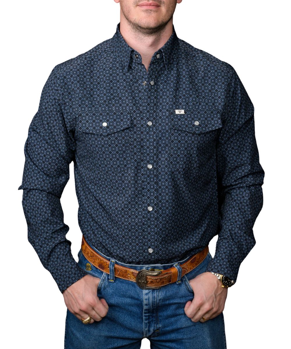 Man wearing a men's black long sleeve pearl snap shirt with blue geometric print, front view