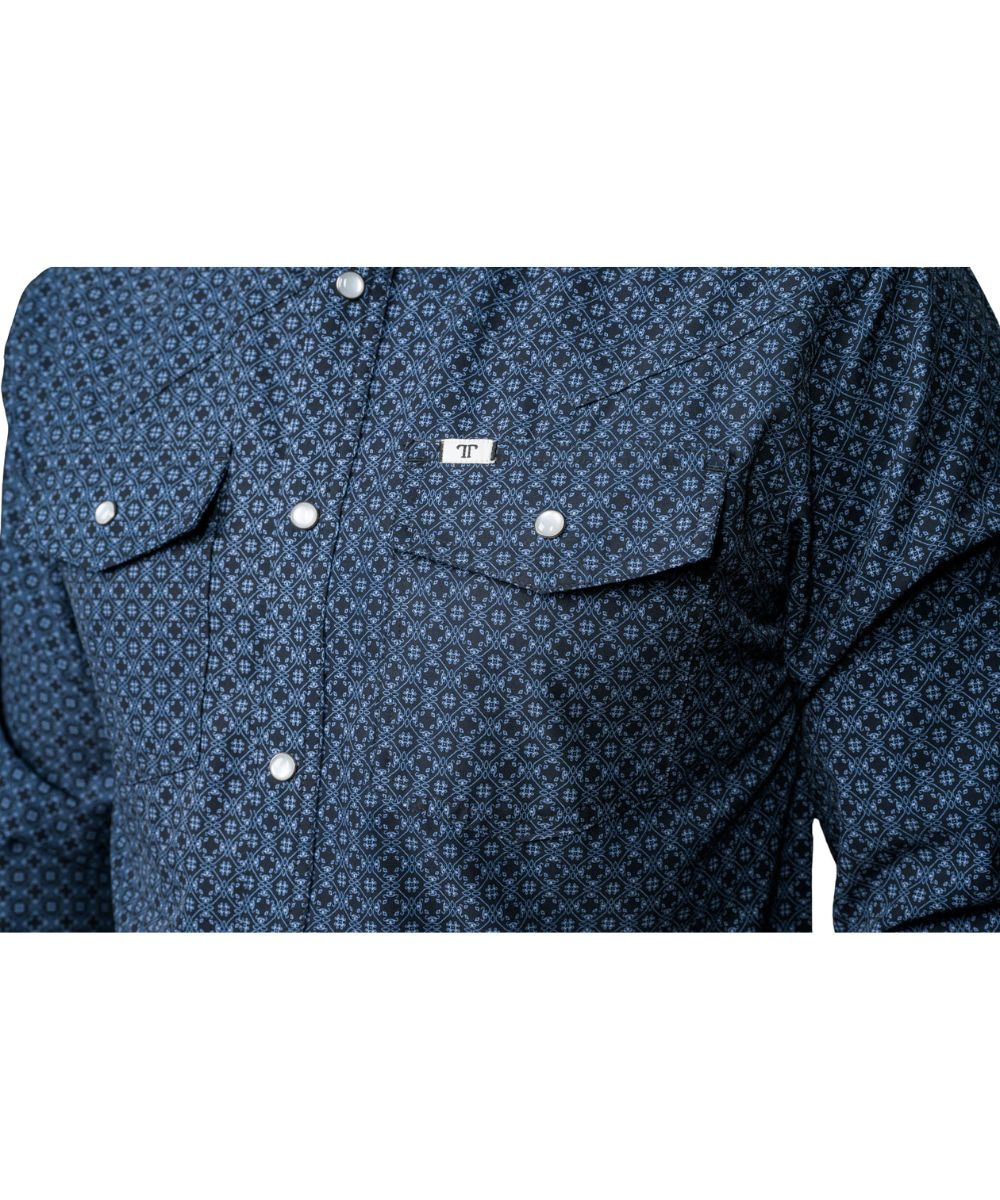 Close-up of men's black pearl snap shirt with blue geometric print showing chest pockets, pen slot, and hidden snap collar
