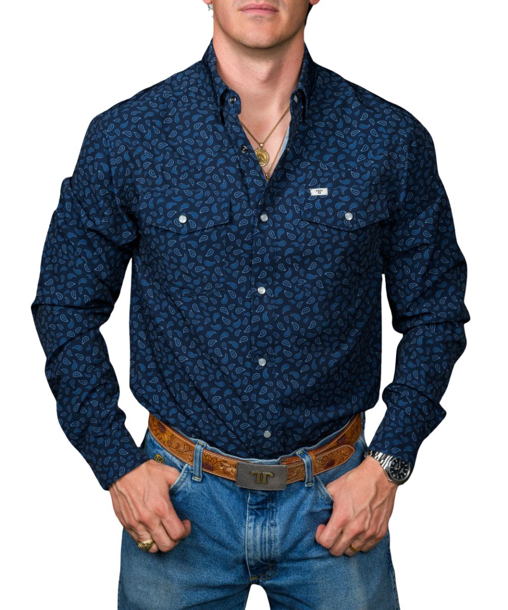 Front view of the men's navy Ferrell Brand long sleeve pearl snap shirt featuring the hidden snap down collar, chest pockets, paisley print, and wrinkle resistance