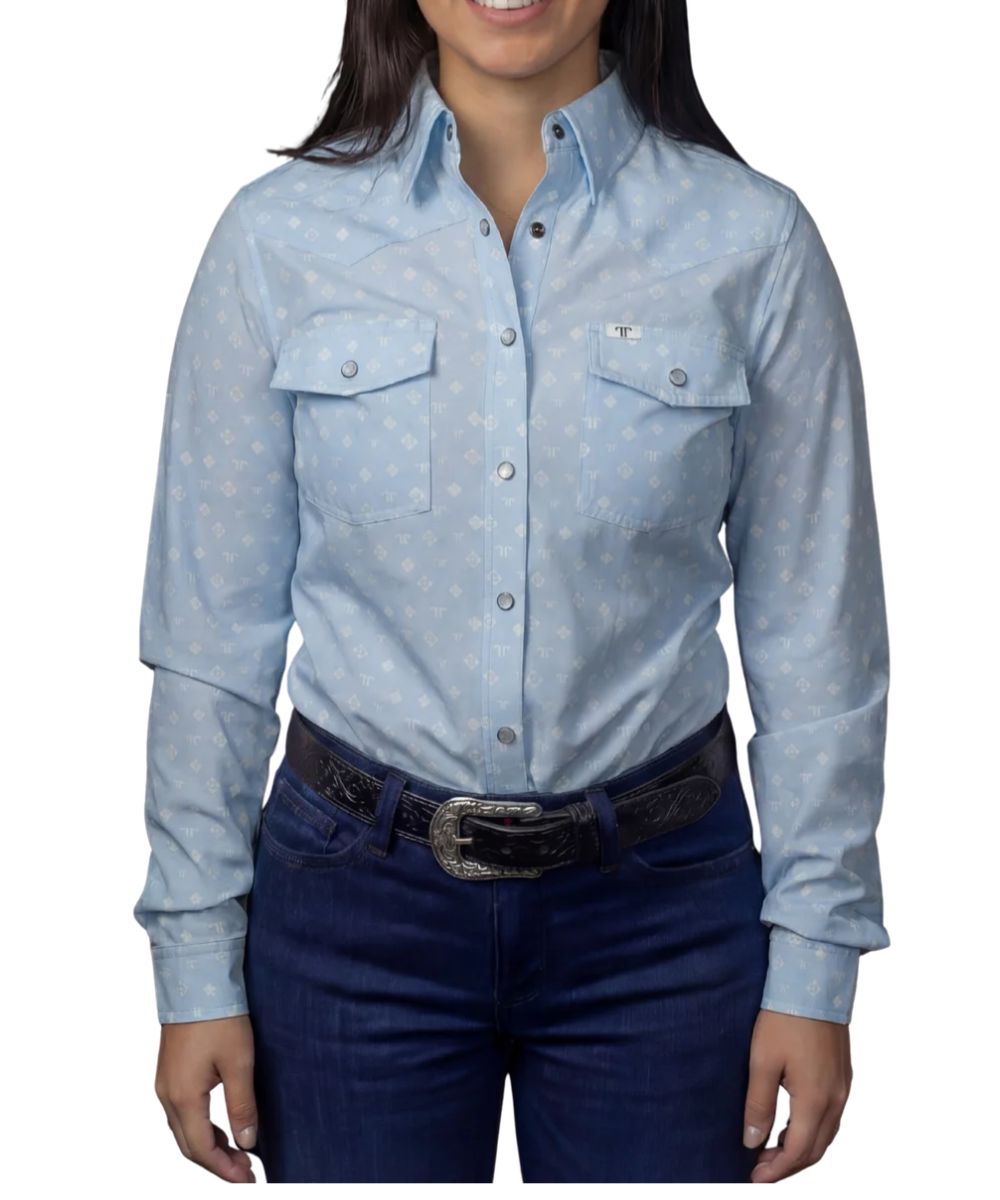 Front view of the women's light blue long sleeve snap shirt featuring the hidden snap down collar, snap flap chest pockets, western yokes, geometric print, and a pen/sunglasses slot in the left chest pocket