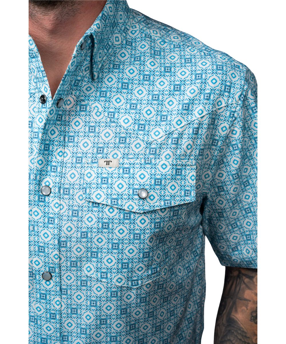 Close-up view of the blue geometric print, hidden snap down collar, and pen slot