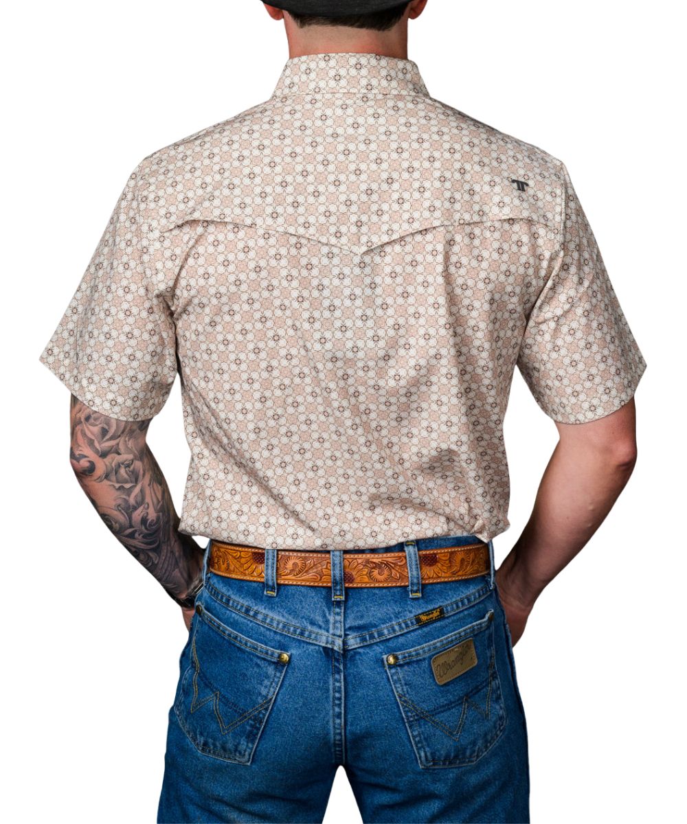 Back view of the men's cream short sleeve pearl snap shirt featuring the geometric floral print, and single point western yokes