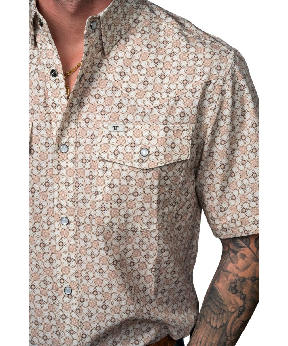 Close-up view of the geometric print, hidden snap-down collar, snap flap chest pockets with a pen/sunglasses slot, and western yokes