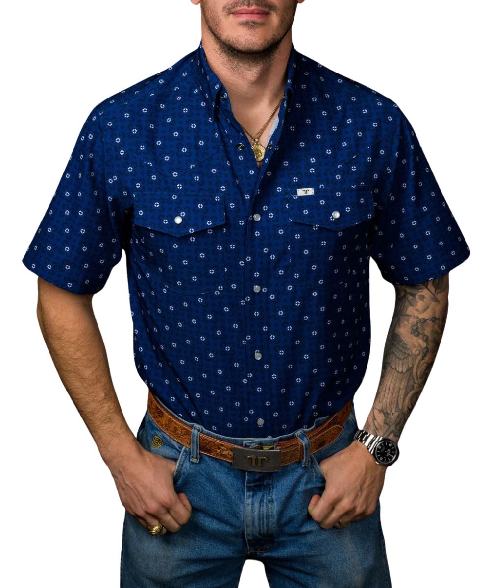 Front view of the men's royal blue Ferrell Brand short sleeve snap shirt featuring the hidden snap down collar, pearl snaps, chest pockets, and geometric print