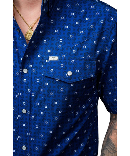Close-up view of the men's blue snap shirt featuring the geometric print and the snap flap chest pockets with a pen slot and logo label at the left chest pocket