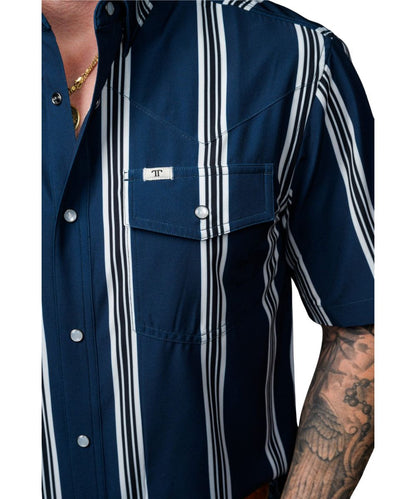 Close-up view of the left single point snap flap chest pocket with a pen/sunglasses slot and logo label featuring the single point western yokes