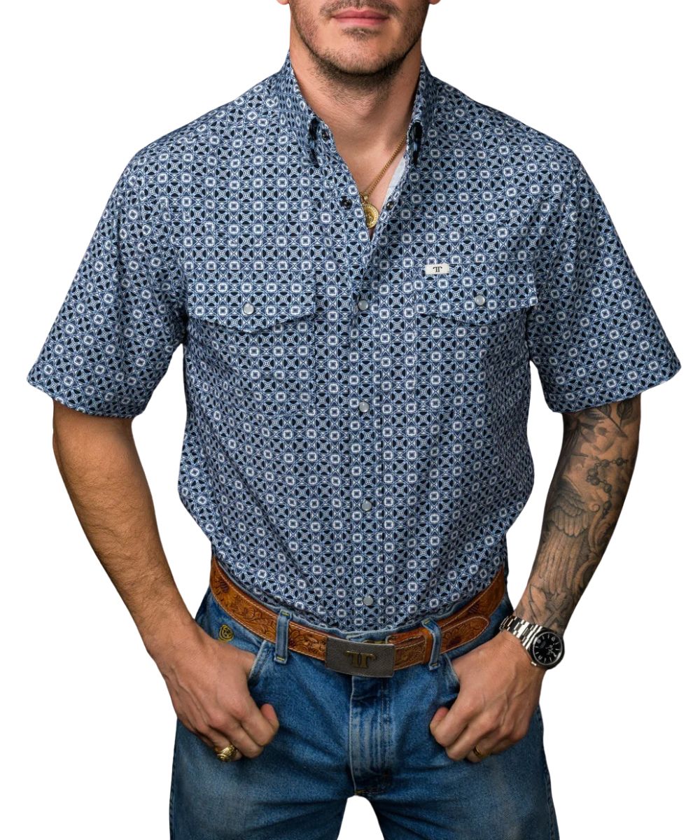 Front view of the men's blue Ferrell Brand short sleeve snap shirt featuring the pearl snaps, snap down collar, chest pockets, geometric print, and wrinkle resistance