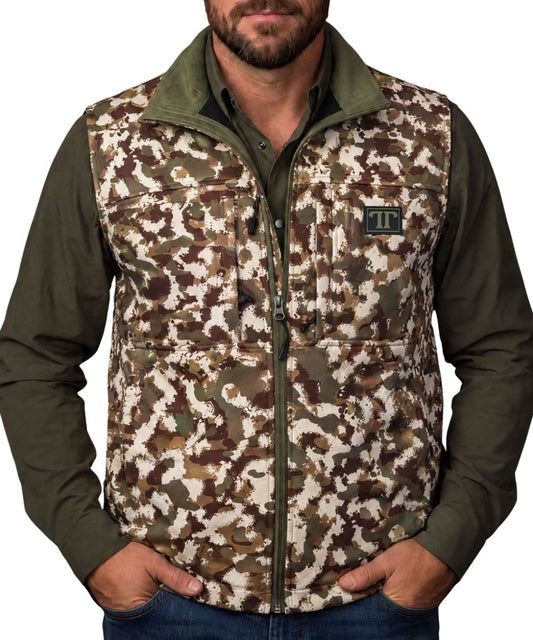 Front view of the men's camo Ferrell Brand vest featuring the mock collar, zip-up closure, zippered chest pockets, logo patch, and zippered hand pockets