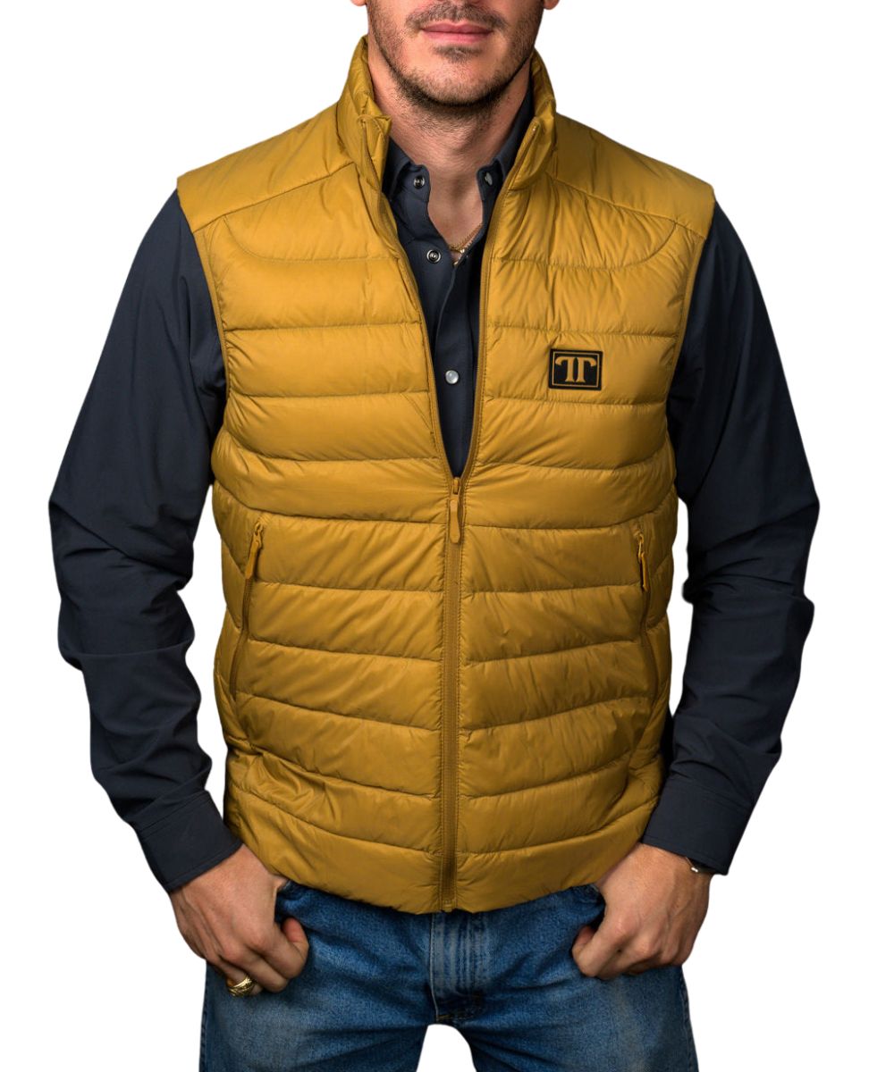 Front view of the men's brown Ferrell Brand sleeveless vest featuring the mock collar, logo patch at the left chest, zip-up closure, lightweight insulation, and zippered hand pockets