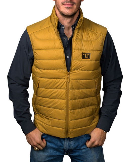Front view of the men's brown Ferrell Brand sleeveless vest featuring the mock collar, logo patch at the left chest, zip-up closure, lightweight insulation, and zippered hand pockets