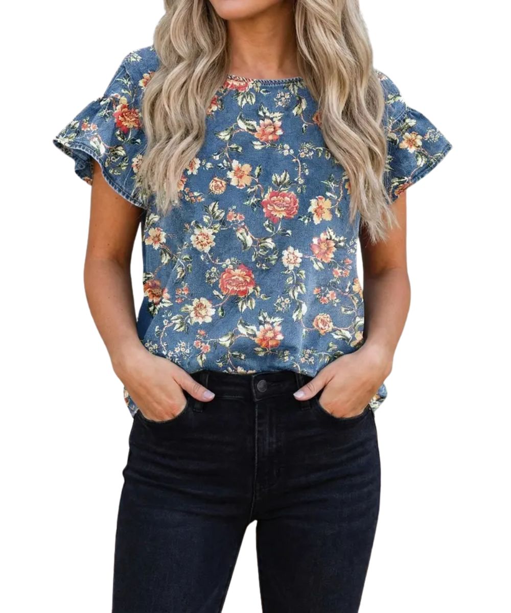 Front view of the women's ashleigh blue denim blouse featuring a floral print, round neckline, and short ruffle sleeves