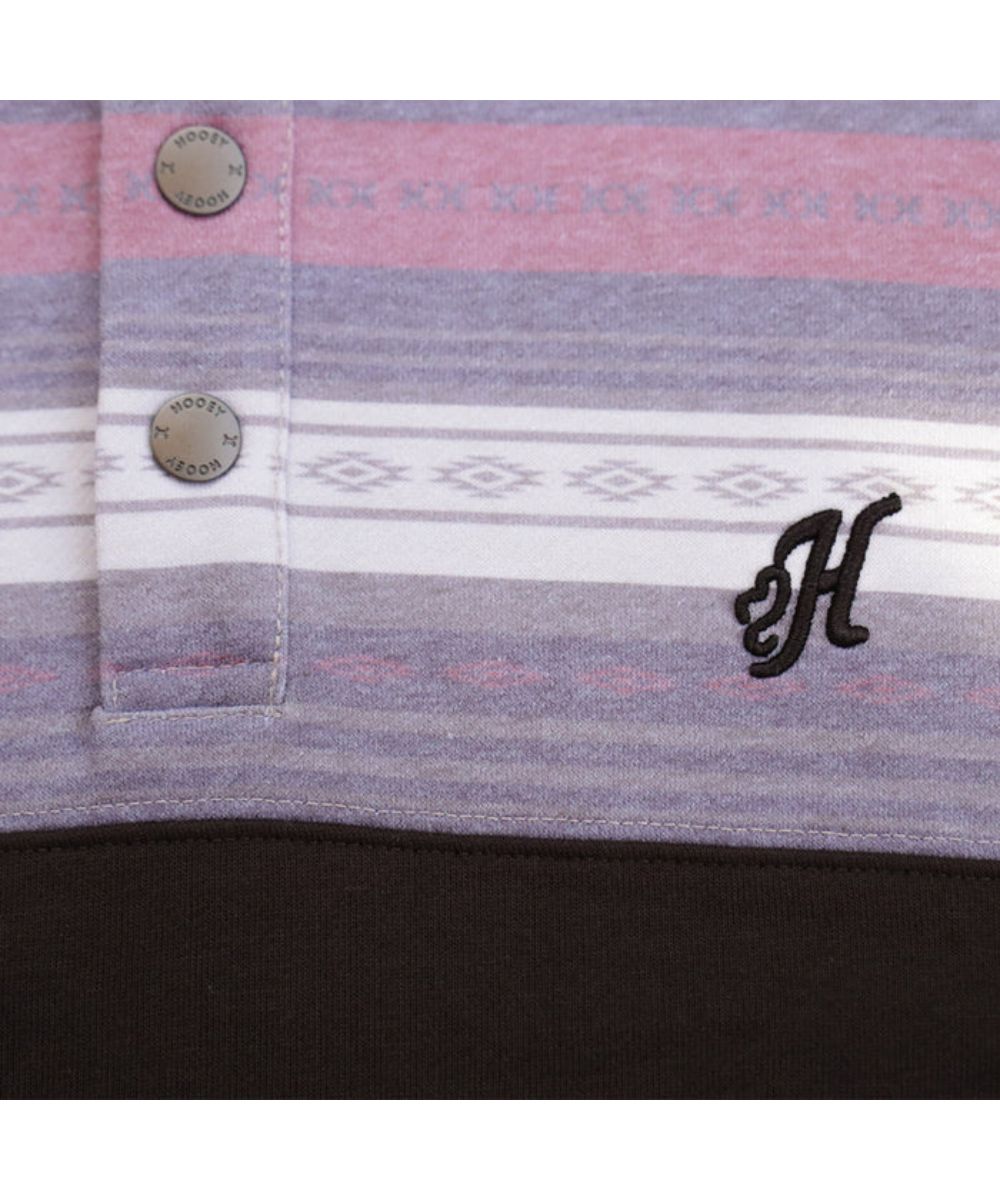Close-up view of the logo custom snaps on the 5-snap placket and logo embroidery at the left chest