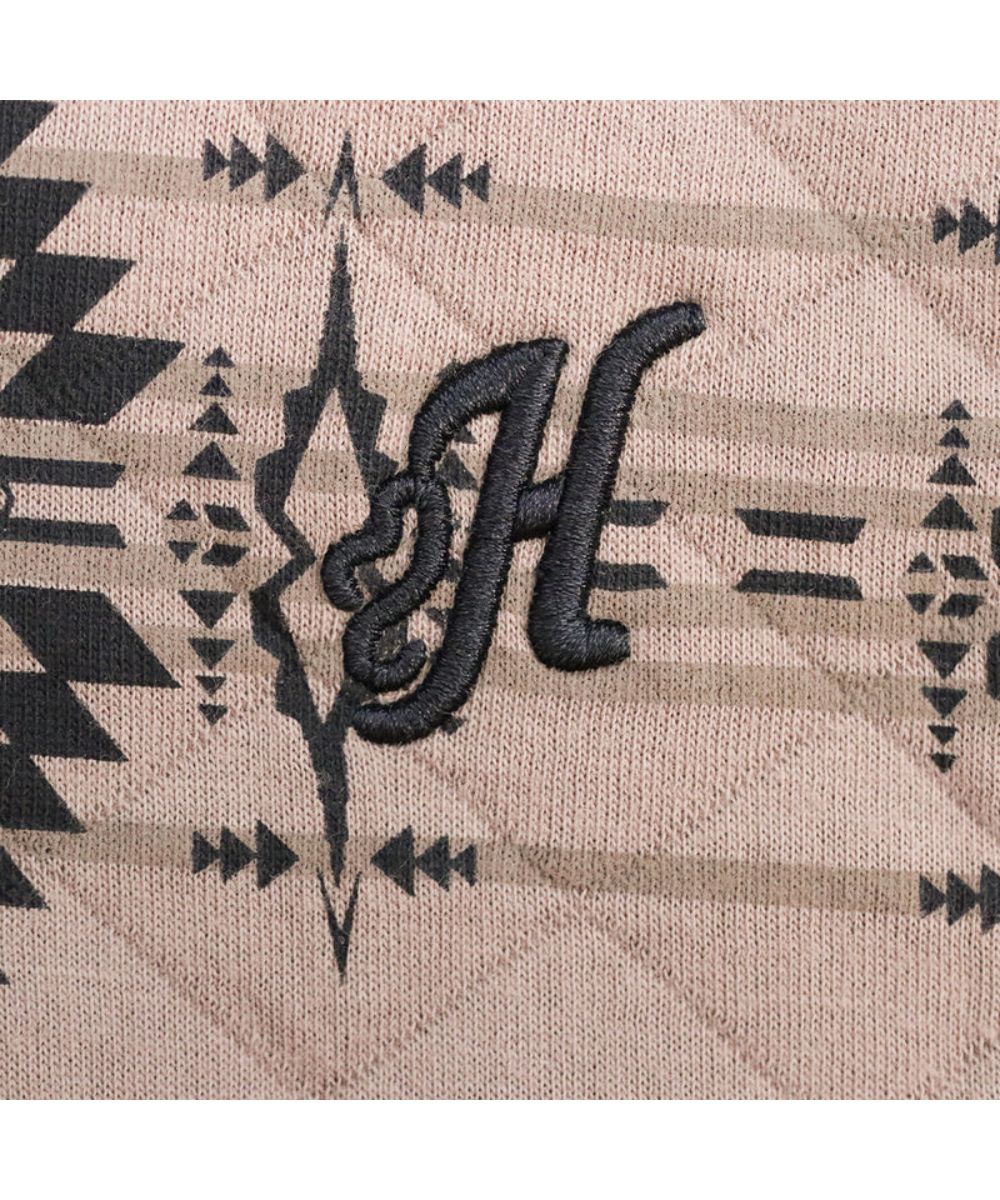 Close-up view of the logo embroidery at the left chest