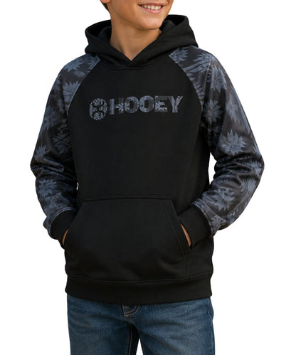 Model view of the boy's black logo hoodie featuring the charcoal aztec printed accents