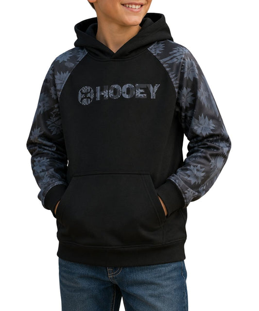 Model view of the boy's black logo hoodie featuring the charcoal aztec printed accents