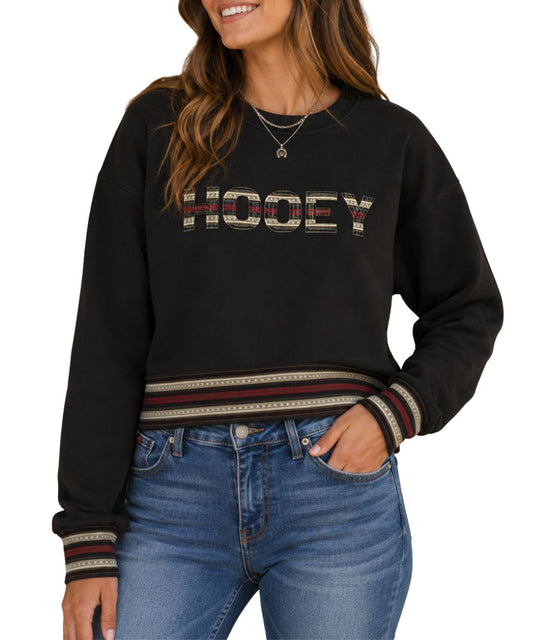 Model view of the women's dark brown crew neck pullover featuring the southwestern-inspired design