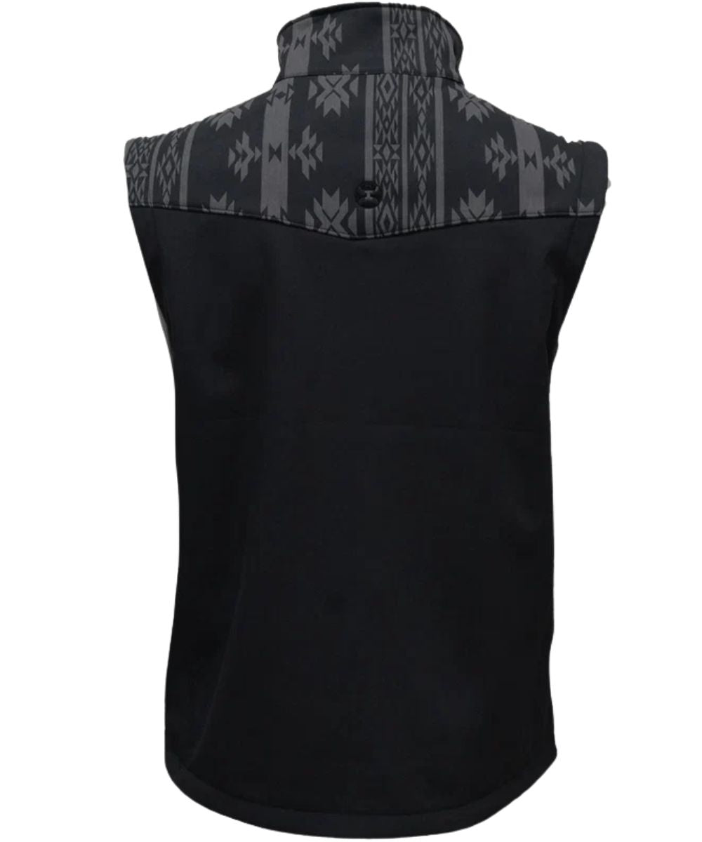 Back view of the boy's black softshell vest featuring the single point grey aztec western yoke