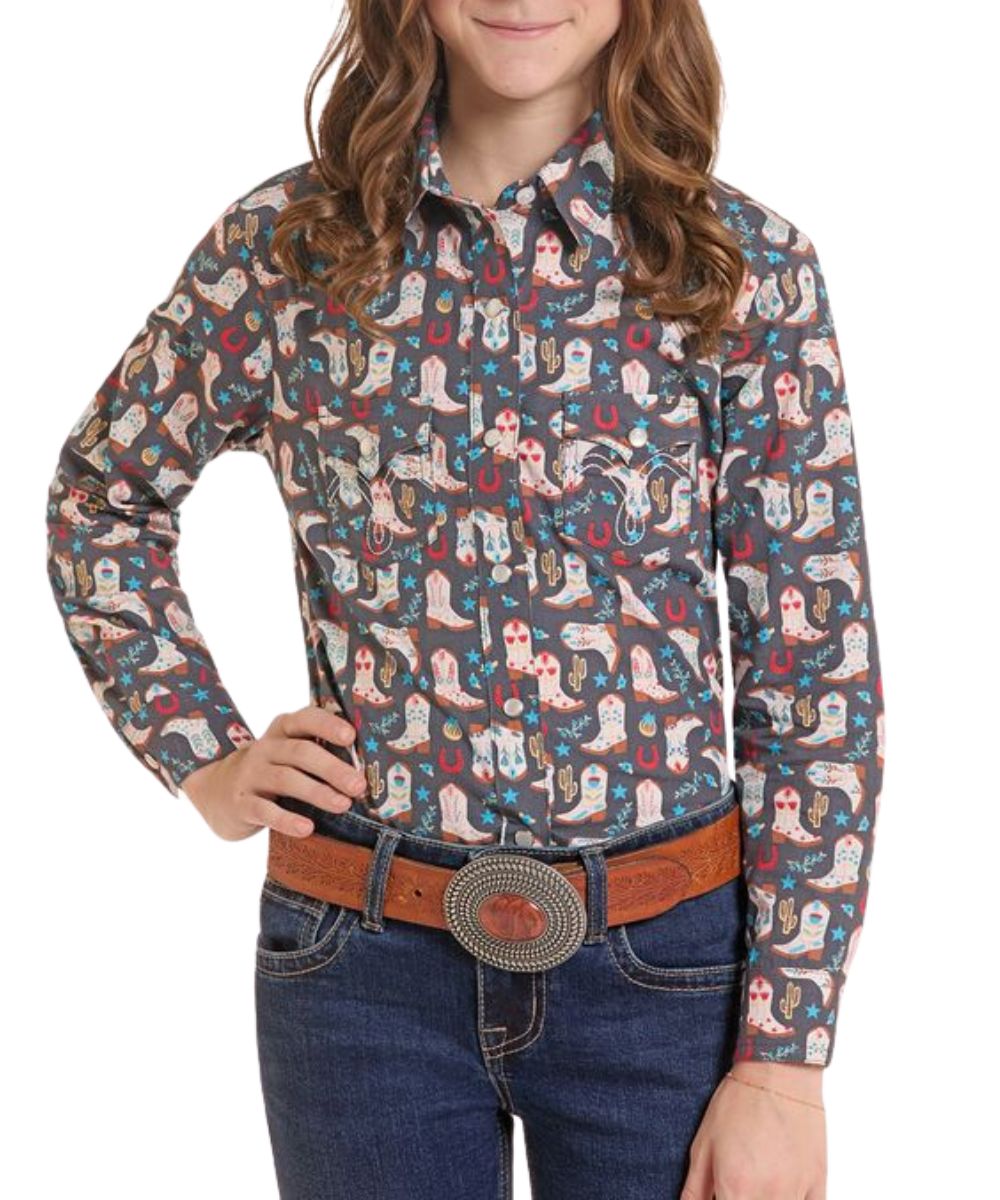 Front view of the girl's dark grey Panhandle Slim long sleeve snap shirt featuring the spread collar, snap flap chest pockets, and the geometric boot print
