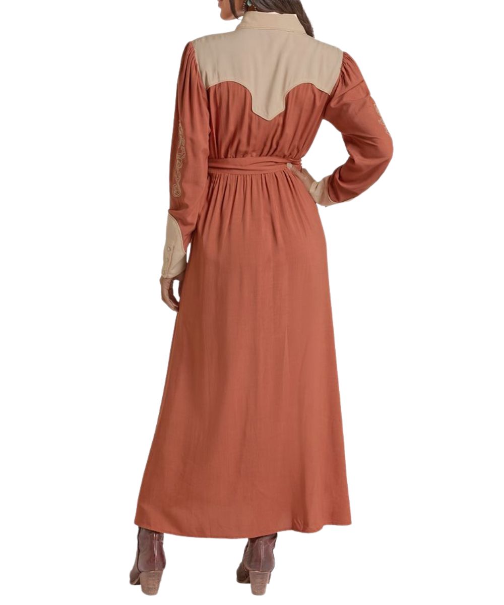 Back view of the women's long sleeve maxi dress featuring the curved western yokes, snap cuffs, self-tie waist belt, and decorative embroidery at the sleeves