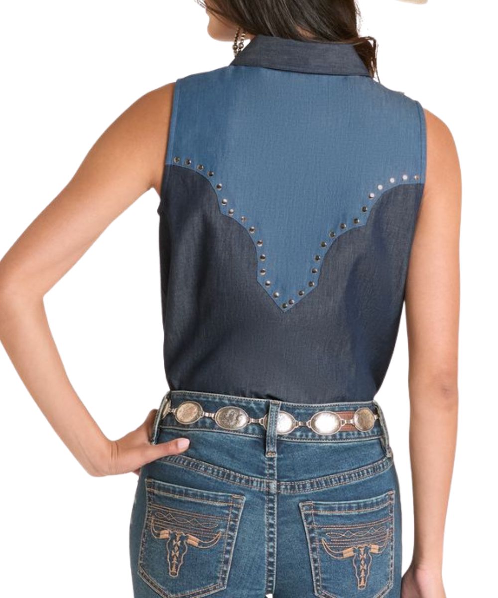 Back view of the women's medium wash denim snap shirt featuring color blocked retro yokes