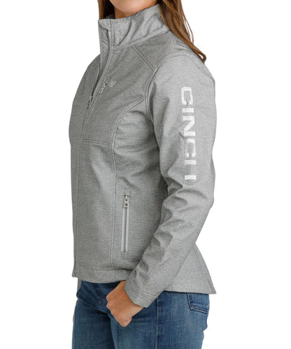 Side view of the women's grey jacket featuring the metallic logo embroidery at the chest and left sleeve