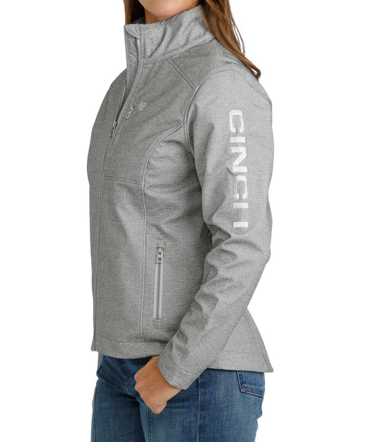 Side view of the women's grey jacket featuring the metallic logo embroidery at the chest and left sleeve