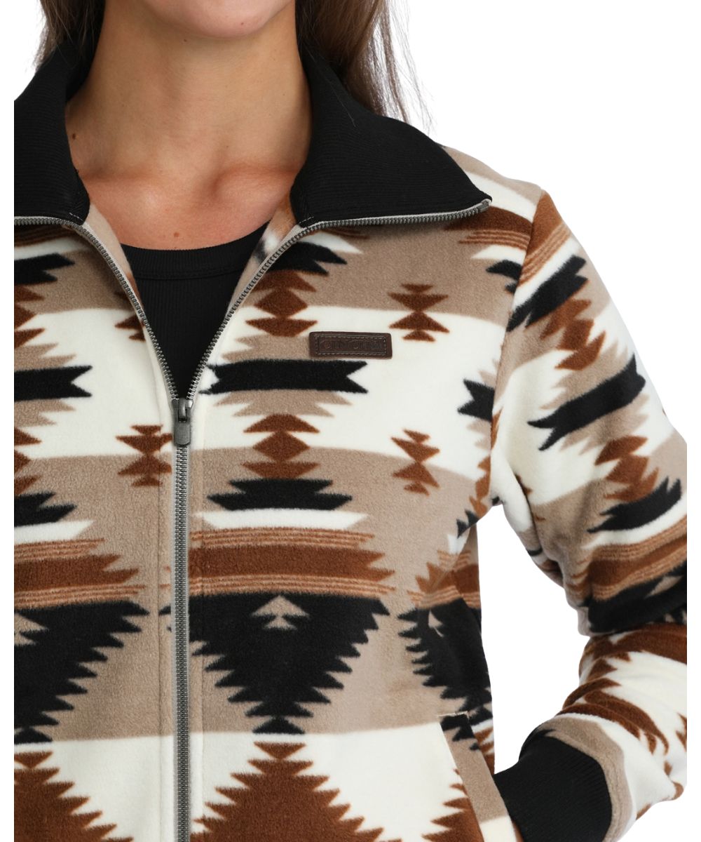 Close-up view of the aztec printed polar fleece featuring the leather logo label at the chest