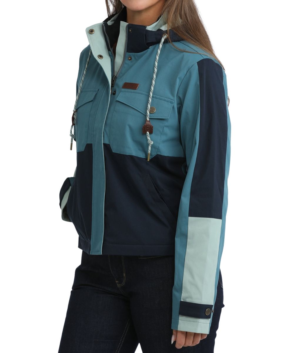 Side view of the side hand pockets, teal color blocked design, cropped length, and snap cuffs