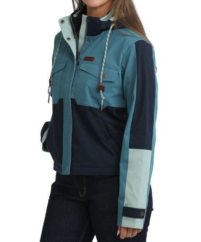 Side view of the side hand pockets, teal color blocked design, cropped length, and snap cuffs