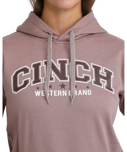 Close-up view of the logo screen printed on front chest that reads: "Cinch Western Brand" featuring the contrast drawcord on the women's lilac hoodie