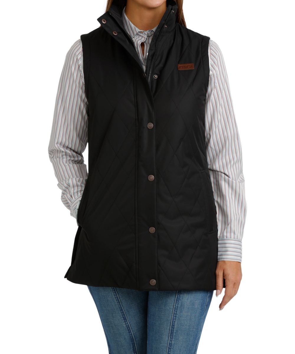 Front view of the women's black Cinch quilted canvas barn vest featuring the durable water-resistant finish, storm flap, zip closure, mock collar, and hand pockets