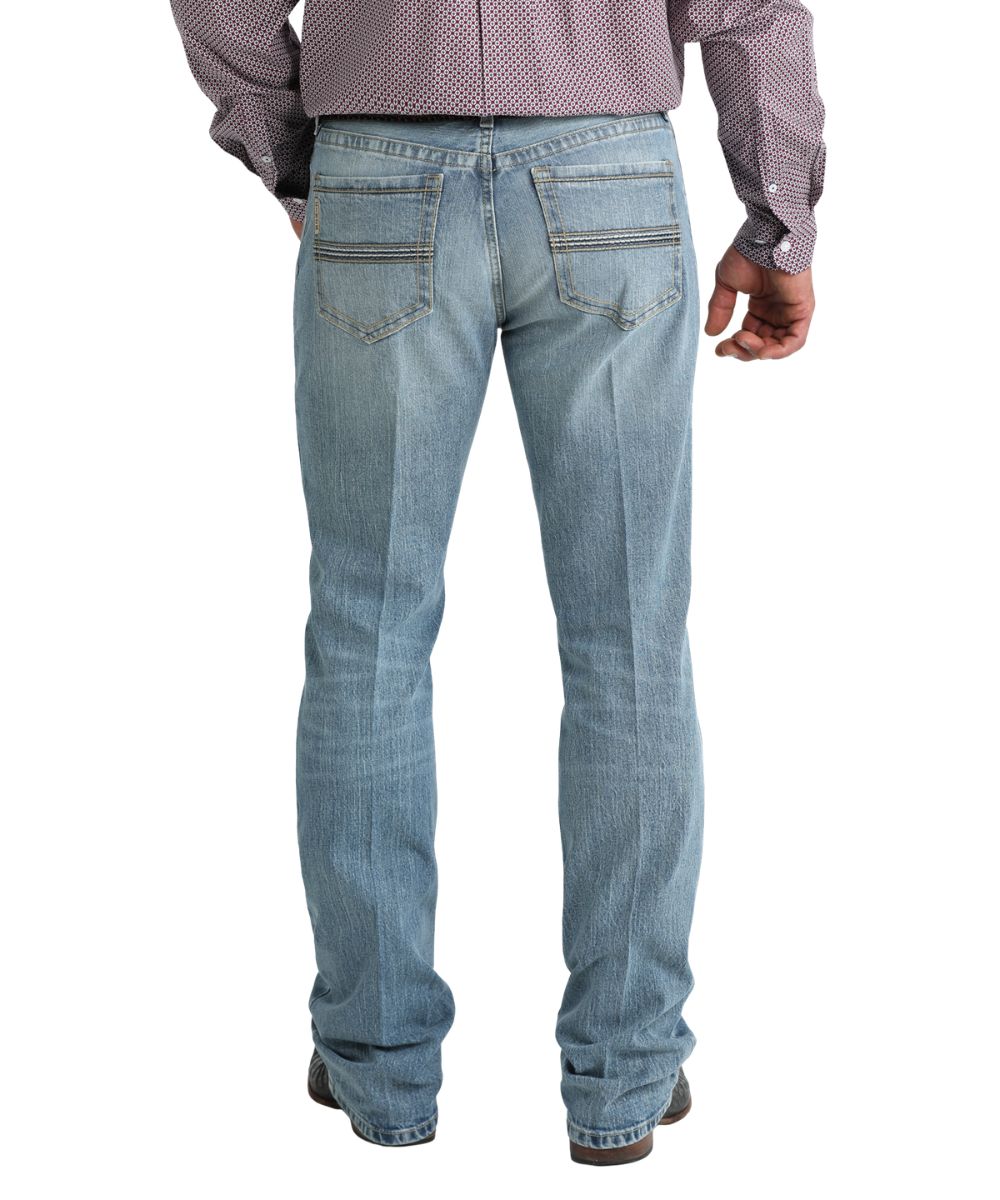 Back view of the men's mid-rise slim fit boot cut jean in a medium stonewash featuring five pocket styling