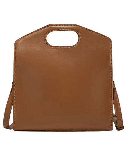 Back view of the women's brown faux leather handbag with a top handle cutout and a shoulder strap