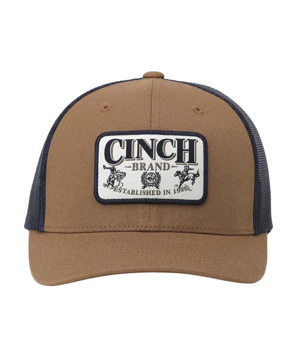 Front view of the men's brown trucker cap featuring the logo patch on the front and the brown curved bill