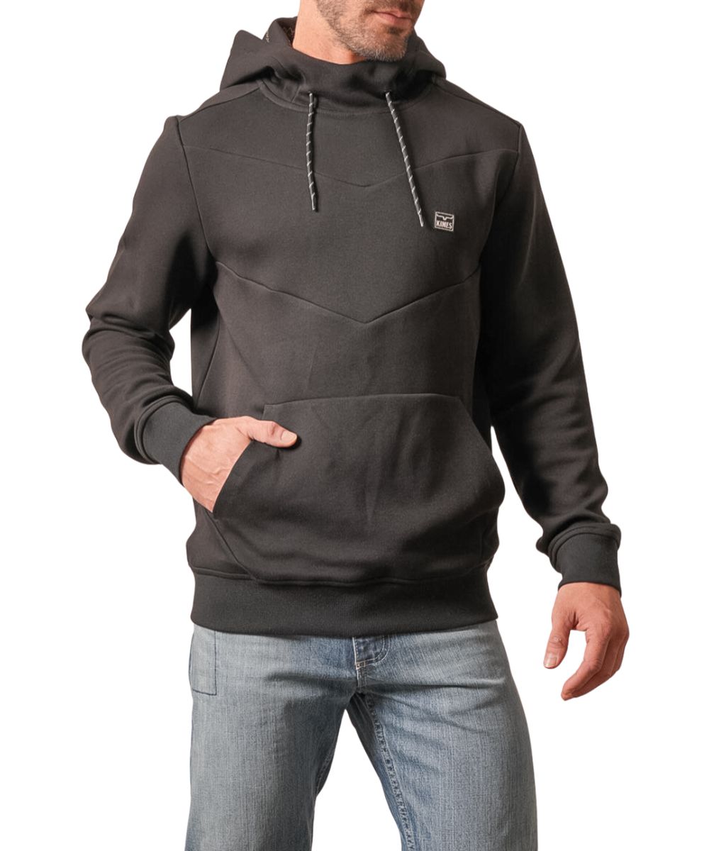 Front view of the men's black Kimes Ranch Inman Hoodie featuring the long sleeves, cowl neck, hooded collar with contrast drawstring, rubber logo patch at the left chest, chevron seam detailing across the chest, kangaroo pocket, and ribbed cuffs and hem