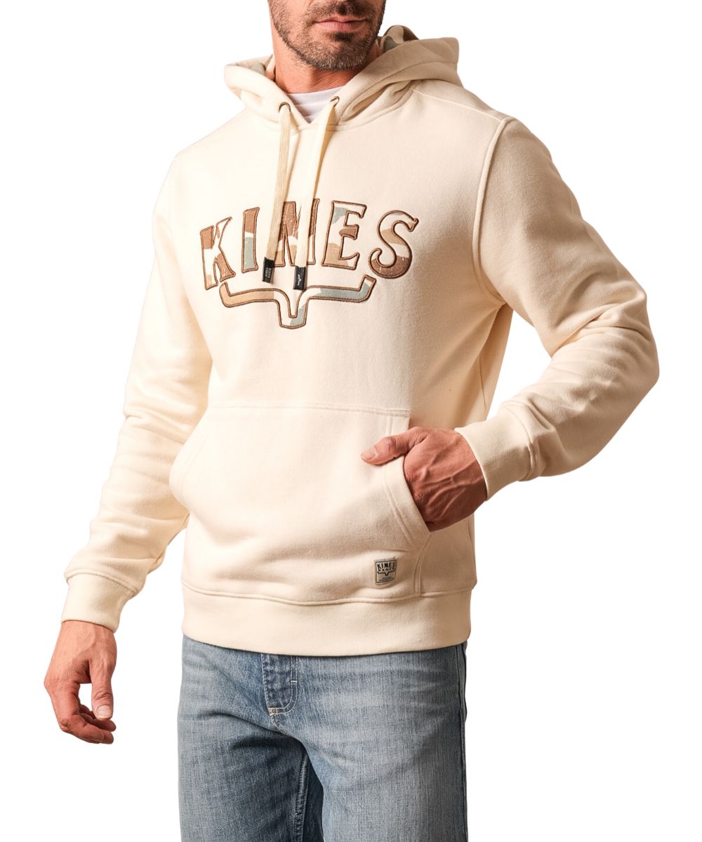 Front view of the men's natural Kimes Ranch Hoodie featuring the hooded collar with a drawstring, logo embroidery at the chest with a camo fill, kangaroo pocket, and rib knit trim