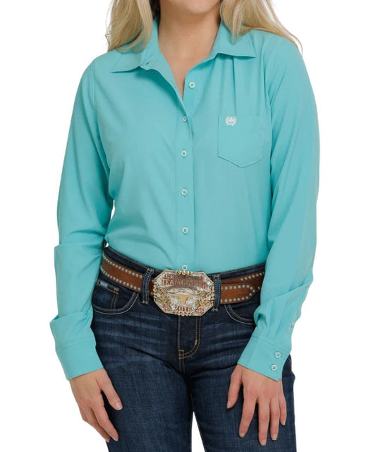 Front view of the women's long sleeve button down shirt featuring the solid turquoise print on the arenaflex fabric