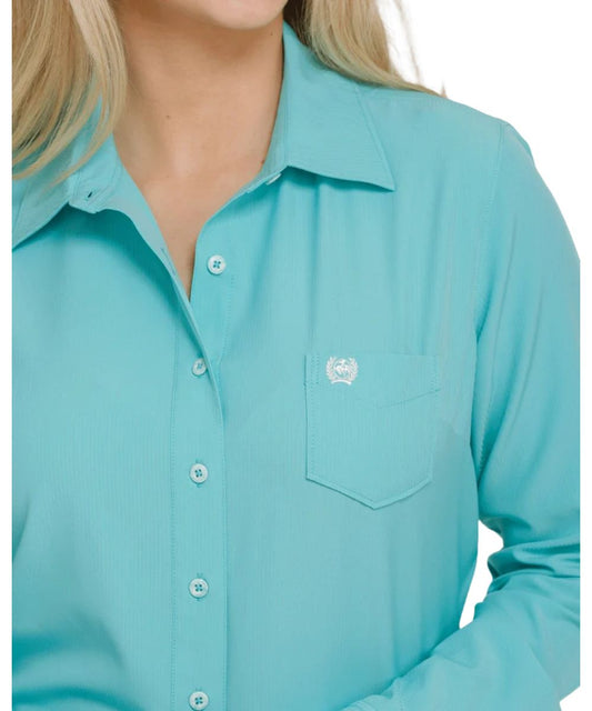 Close-up view of the women's long sleeve button down shirt featuring the single open chest pocket and the breathable moisture wicking arenaflex fabric