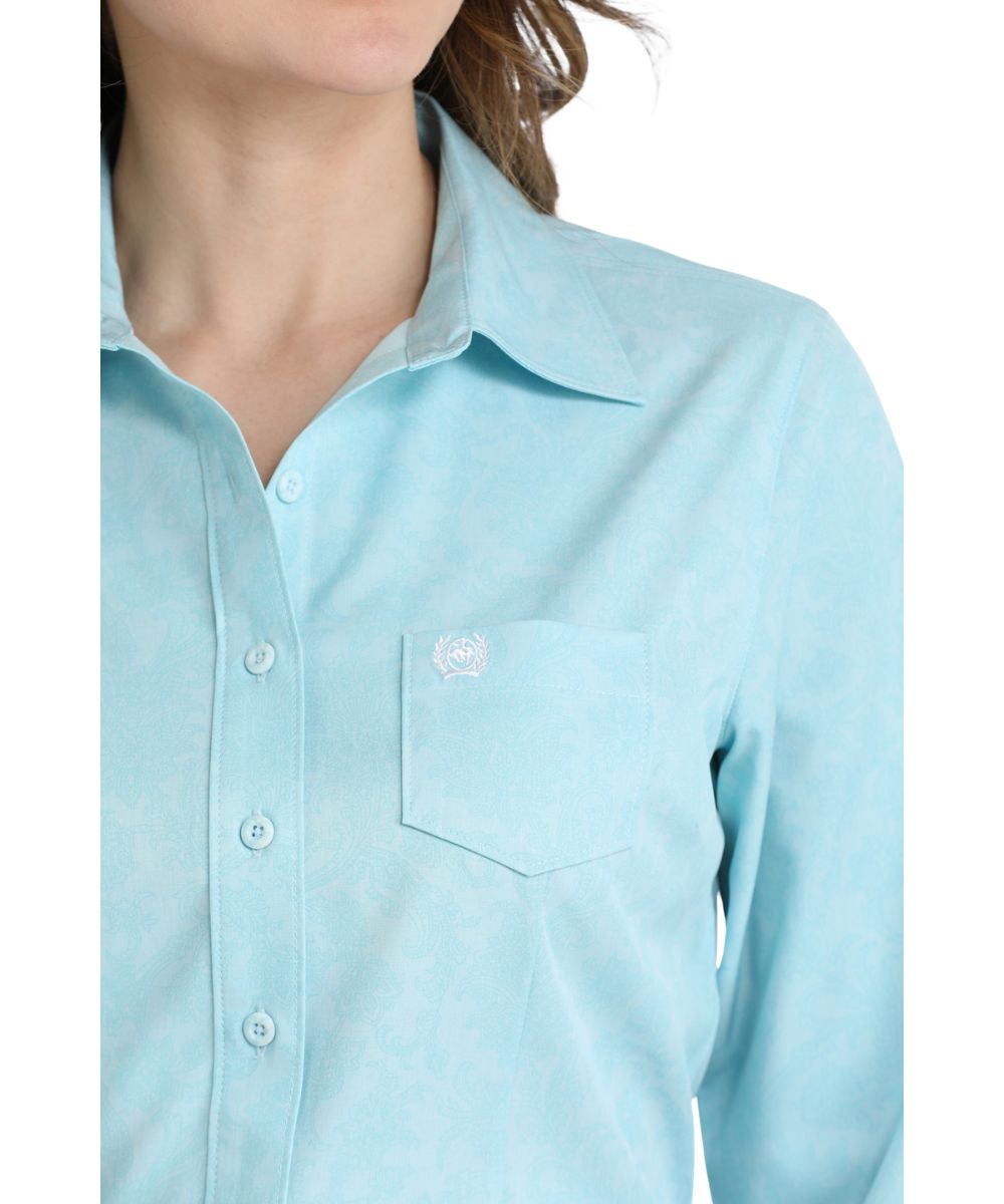 Close-up view of the women's light blue long sleeve button down shirt