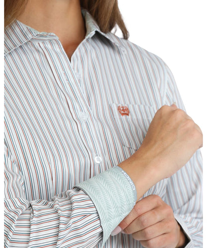 Close-up view of the women's long sleeve button down featuring the contrast interior trim, striped print, and chest pocket