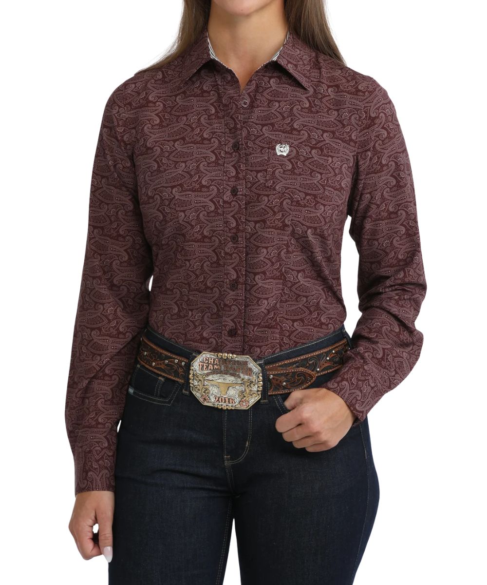 Front view of the women's purple Cinch ArenaFlex long sleeve button down shirt featuring the spread collar, chest pocket, purple buttons, and paisley print