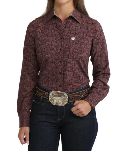 Front view of the women's purple Cinch ArenaFlex long sleeve button down shirt featuring the spread collar, chest pocket, purple buttons, and paisley print