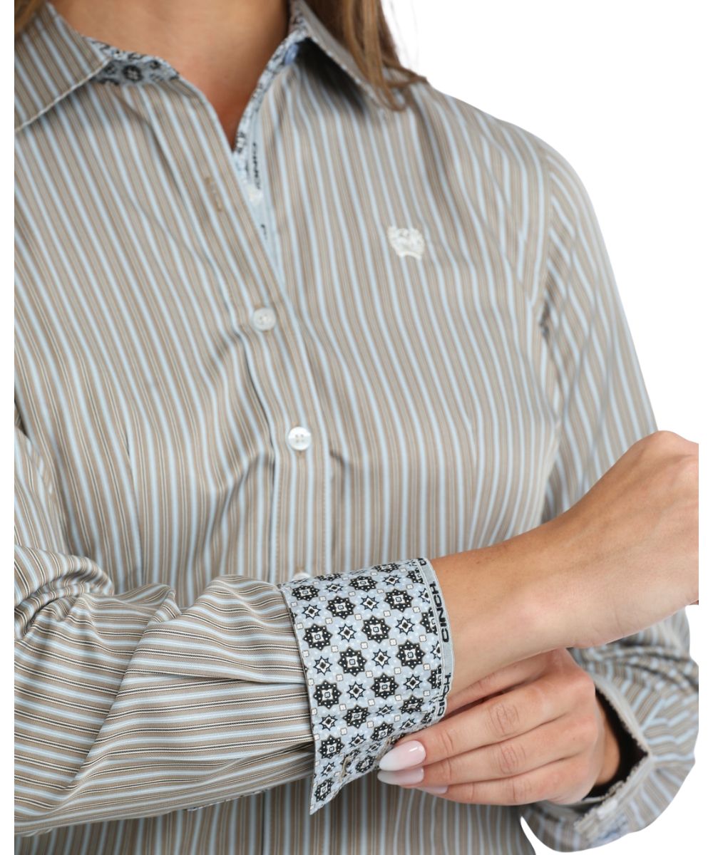 Close-up view of the vertical striped print, white buttons, and contrast interior trim