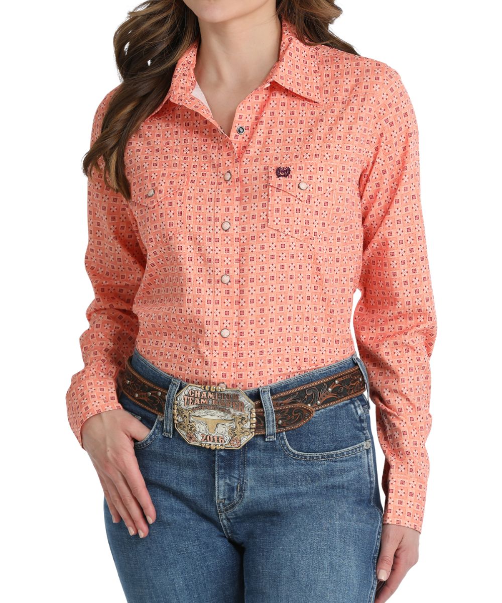 Front view of the women's coral geometric print western snap shirt featuring snap flap chest pockets and marble snaps