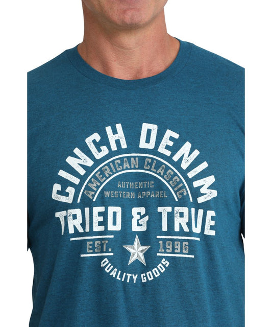 Close-up view of the front screen print that reads: "Cinch Denim - Tried And True - Quality Goods- American Classic - Authentic Western Apparel - Est. 1996"