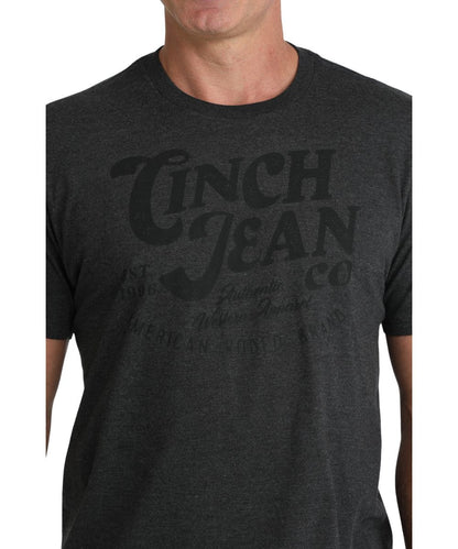 Close-up view of the front screen print reads: "Cinch Jean Co." on charcoal shirt