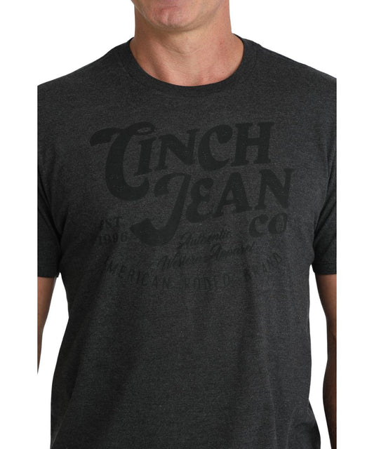 Close-up view of the front screen print reads: "Cinch Jean Co." on charcoal shirt
