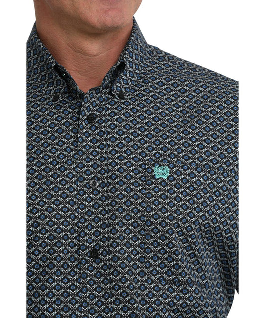 Close-up view of the blue geometric print on the black long sleeve button down shirt 