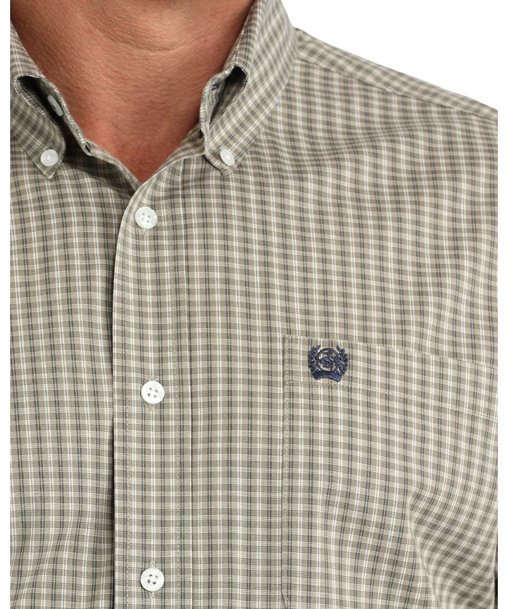 Close-up view of the olive plaid print and button down collar